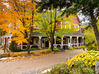 The main building of the Le Baluchon eco-resort in a fall setting.