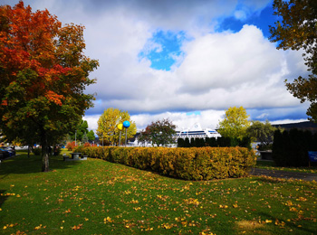 View of the autumnal scenery and a cruise ship in the Saguenay.