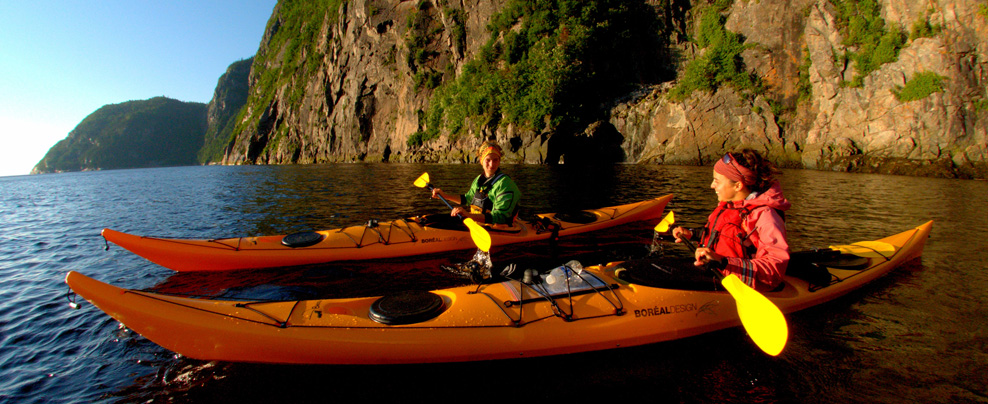 Two kayakers watching the sunset.