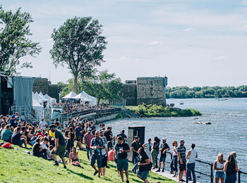 A crowd gathered by the water during a festival.