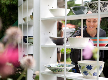 Smiling woman looking at ceramic bowls.