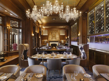 The dining room of the Champlain restaurant, featuring a large chandelier.