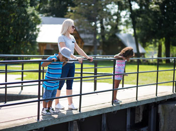 Mother and two children on the bridge at the canal