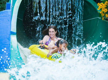 Mother and daughter on a water slide.