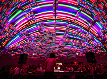 Tech music show under a colourful luminous arch