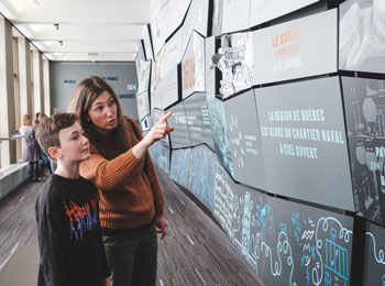 A mother and her son looking at an exhibit.