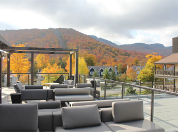 Mezzanine of the Espace 4 Saisons hotel with a view of the fall-coloured Mount Orford.