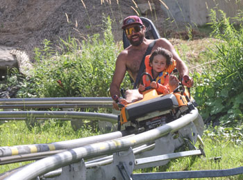 A father and son in the alpine rollercoaster.