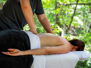 Woman getting a back massage on a massage table.