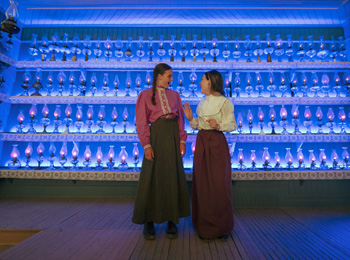 Two actresses in period costumes at the Village Québécois d'Antan.