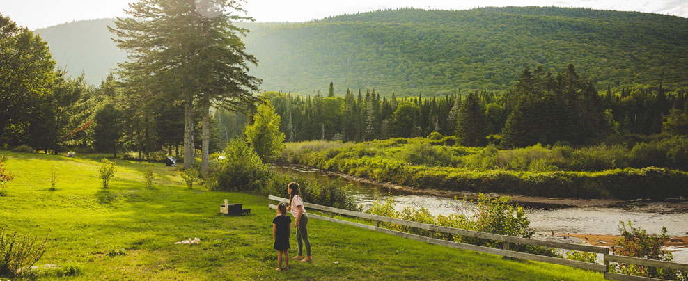 A mother and daughter in a wide-open natural landscape.