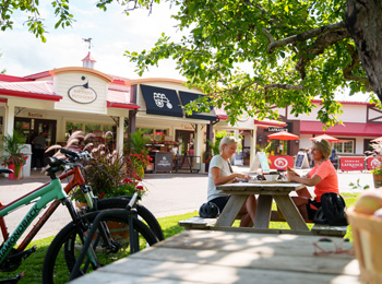 Two women on a picnic table at Domaine Lafrance.