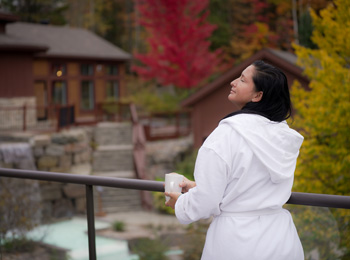 Woman in a spa robe standing next to the heat circuit installations.