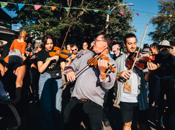 Musicians at the Ripon folk festival surrounded by a dancing audience.