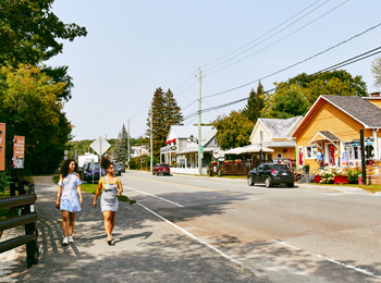 Two young girls exploring the main street in the village of Montebello.