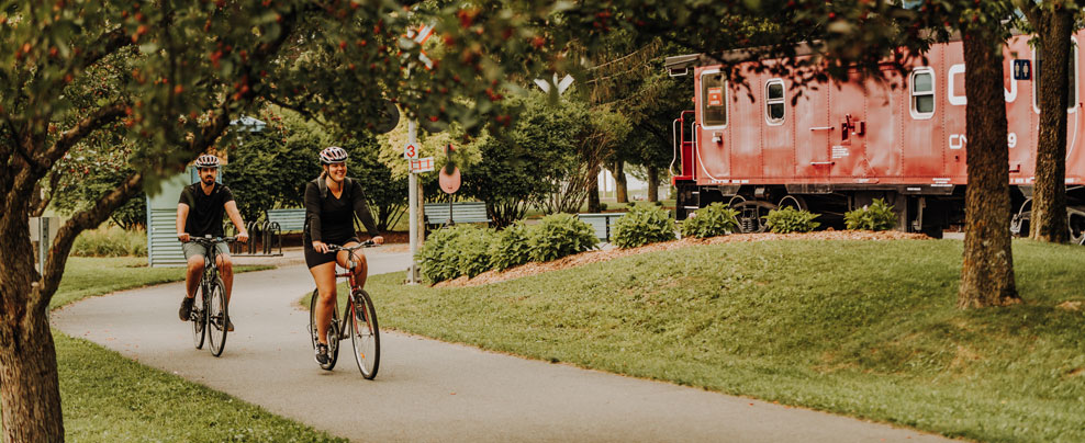 Couple on bicycles on a paved path.