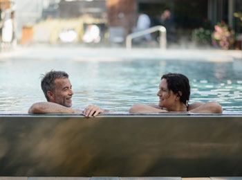 Two people soaking in a thermal pool.