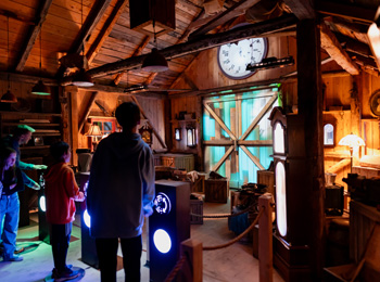 Family in the clock workshop at the Village Québécois d'Antan